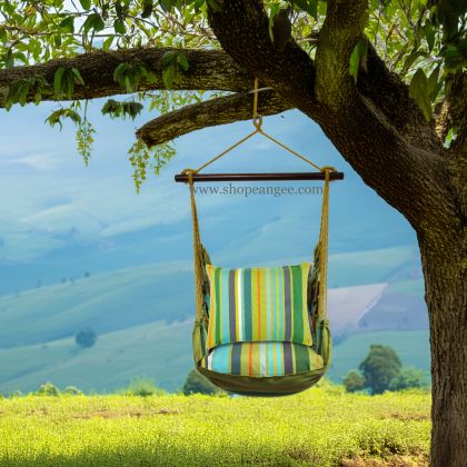 In a shaded porch swing a multi colored outdoor swing crafted by the artisans of Magnolia Casual called the Swing Set 4 piece Citrus Stripe w/ Citrus Stripe is displayed featuring 100 percent weather resistant fabric, weather resistant polyester fabric, handcrafted adding comfort and style to the space featuring with a stripe motif.