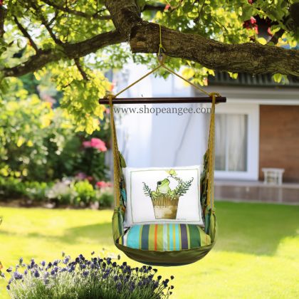 In a shaded porch swing a multi colored outdoor swing crafted by the artisans of Magnolia Casual called the Swing Set 4 piece Citrus Stripe w/ Frog in Pot is displayed featuring 100 percent weather resistant fabric, weather resistant polyester fabric, handcrafted adding comfort and style to the space featuring with a stripe motif.