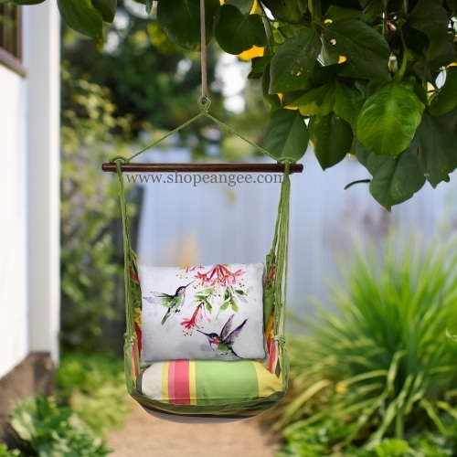 In a shaded porch swing a multi colored outdoor swing crafted by the artisans of Magnolia Casual called the Swing Set 4 piece Fresh Lime Stripe w/ 2 Hummers w/Hanging Plant is displayed featuring 100 percent weather resistant fabric, weather resistant polyester fabric, handcrafted adding comfort and style to the space featuring with a stripe motif and shades of lime.