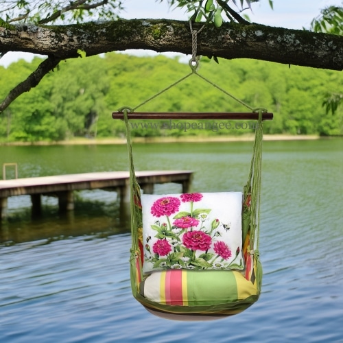 In a shaded porch swing a pink outdoor swing crafted by the artisans of Magnolia Casual called the Swing Set 4 piece Fresh Lime Stripe w/ Zinnias Pink is displayed featuring 100 percent weather resistant fabric, weather resistant polyester fabric, handcrafted adding comfort and style to the space featuring with a stripe motif and shades of lime and pink.