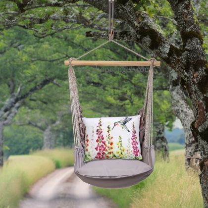 In a cozy garden seating area a gray outdoor swing crafted by the artisans of Magnolia Casual called the Swing Set 4 piece Gray Solid w/ Foxgloves w/Hummingbird is displayed featuring 100 percent weather resistant fabric, weather resistant polyester fabric, handcrafted adding comfort and style to the space featuring with a hummingbird motif and shades of gray.