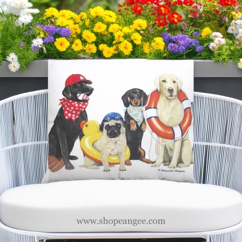 In a coastal inspired deck chair a multi colored outdoor pillow crafted by the artisans of Magnolia Casual called the Outdoor Pillow Dogs of Summer 19x24 is displayed featuring quality outdoor fabric adding comfort and style to the space.