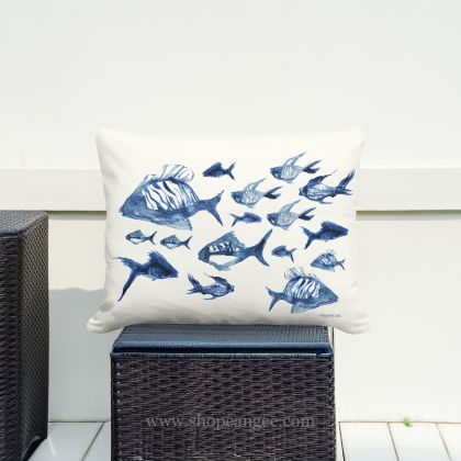 In an outdoor reading nook a multi colored outdoor pillow crafted by the artisans of Magnolia Casual called the Outdoor Pillow Underwater Ballet 19x24 is displayed featuring quality outdoor fabric adding comfort and style to the space.