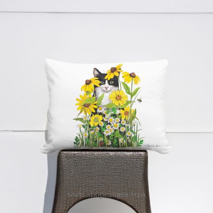 In a cozy garden seating area a multi colored outdoor pillow crafted by the artisans of Magnolia Casual called the Outdoor Pillow Cat with Daisies 19x24 is displayed featuring quality outdoor fabric adding comfort and style to the space featuring with a cat motif.