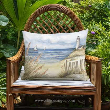 In a sunlit patio lounge a multi colored outdoor pillow crafted by the artisans of Magnolia Casual called the Outdoor Pillow Beach and Lighthouse 19x24 is displayed featuring quality outdoor fabric adding comfort and style to the space.