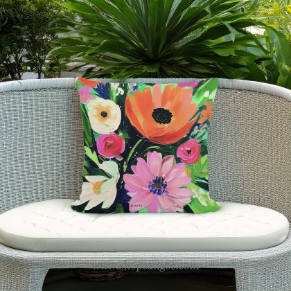 In a shaded porch swing a multi colored outdoor pillow crafted by the artisans of Magnolia Casual called the Outdoor Pillow Spring Fling 18x18 is displayed featuring quality outdoor fabric adding comfort and style to the space.