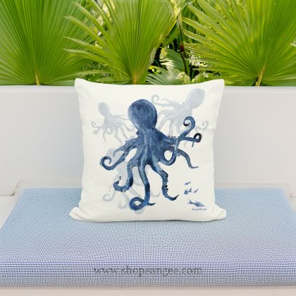 In a coastal inspired deck chair a multi colored outdoor pillow crafted by the artisans of Magnolia Casual called the Outdoor Pillow Indigo Octopus 18x18 is displayed featuring quality outdoor fabric adding comfort and style to the space featuring with a octopus motif.