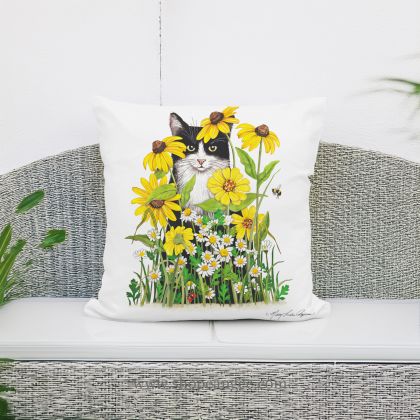 In a sunlit patio lounge a multi colored outdoor pillow crafted by the artisans of Magnolia Casual called the Outdoor Pillow Cat with Daisies 18x18 is displayed featuring quality outdoor fabric adding comfort and style to the space featuring with a cat motif.
