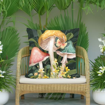 In a sunlit patio lounge a multi colored outdoor pillow crafted by the artisans of Magnolia Casual called the Outdoor Pillow Mushroom Trio 18x18 is displayed featuring handwoven textile adding comfort and style to the space.