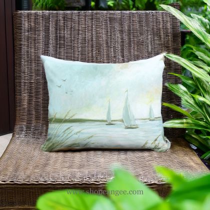 In a cozy garden seating area a multi colored outdoor pillow crafted by the artisans of Magnolia Casual called the Outdoor Pillow Sailboats 13x18 is displayed featuring quality outdoor fabric adding comfort and style to the space.