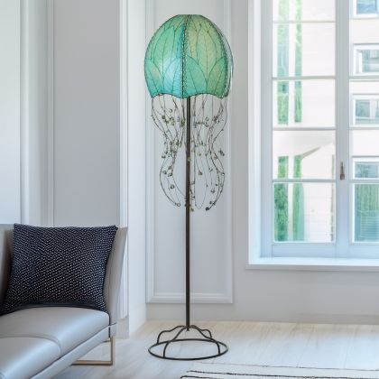 Sea Blue Jellyfish Large Floor Lamp by Eangee Home Design - dome shade formed from fossilized cocoa leaves with iron tendril 'tentacles' dotted by glass beads; sends a serene leaf?filtered light while introducing playful underwater character.