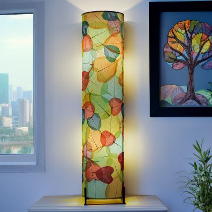 Multicolor Banyan Large Floor Lamp by Eangee Home Design - cylinder of multicolored cocoa leaves radiates warm ambient light after dusk, highlighting leaf veining and adding rhythmic color to contemporary decor.