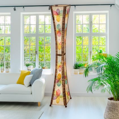 Multicolor Hourglass Giant Floor Lamp by Eangee Home Design - tall hourglass column wrapped in vibrant fossilized cocoa leaves with abaca trim; handcrafted lamp diffuses playful color bands that energize a bright lounge.