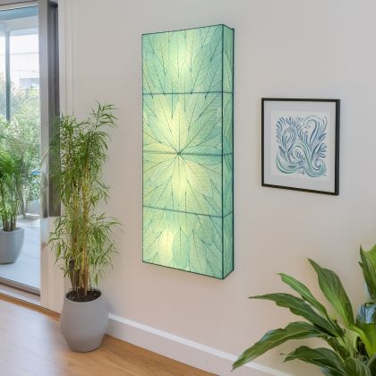 Sunburst Panel Wall Lamp in sea blue by Eangee, vertical triptych of real cocoa leaves glowing beside indoor greenery