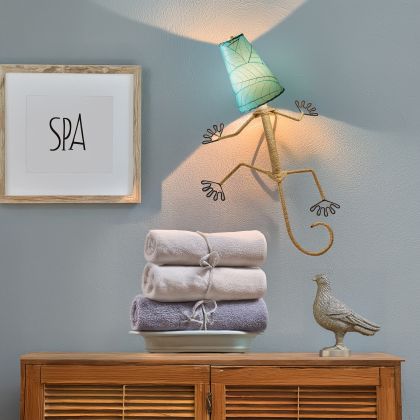 Eangee Home Design Gecko Wall Sconce in sea blue with a shade made of real cocoa leaves, quirky gecko light brightening a spa?inspired bathroom