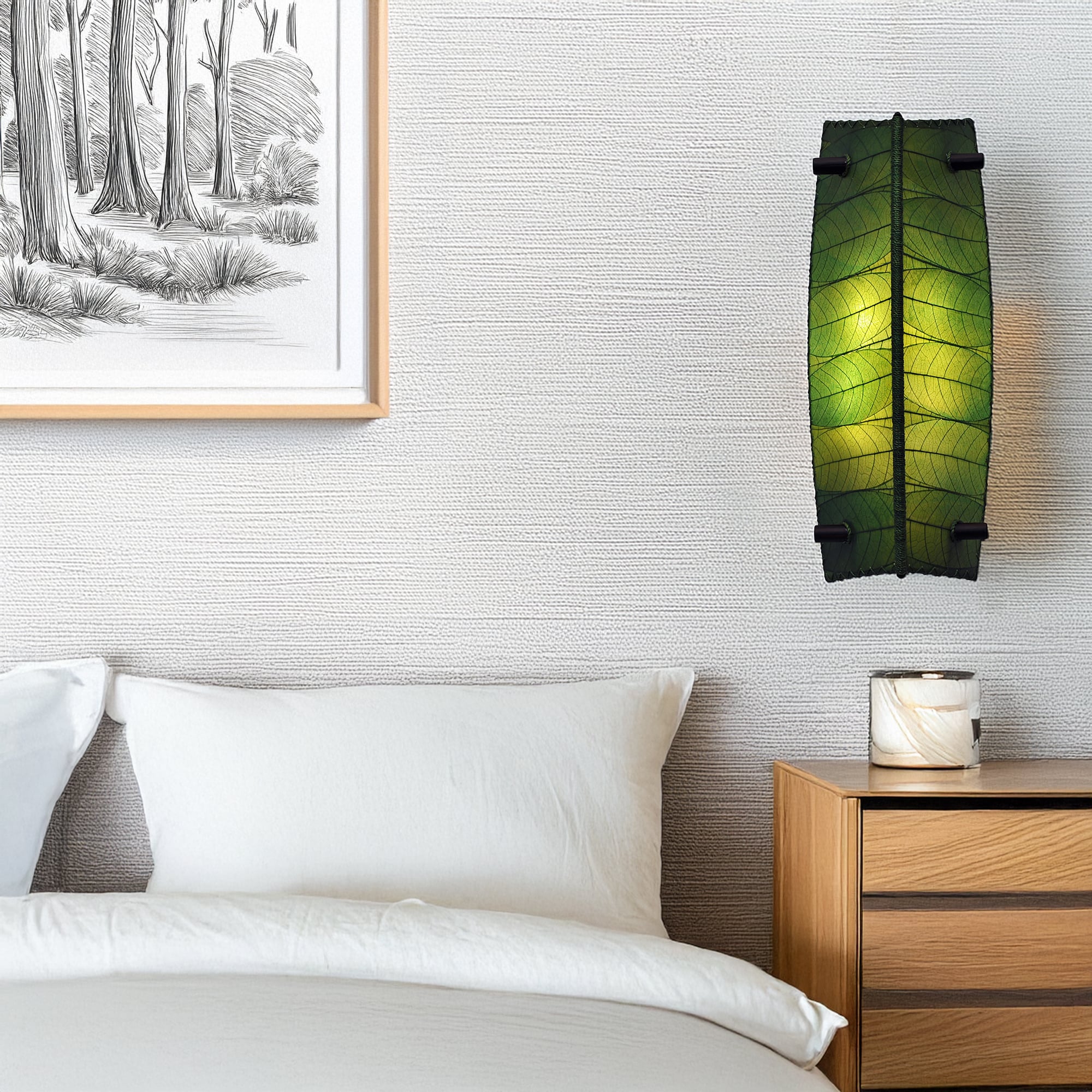 Eangee Home Design Banana Wall Sconce in green with a shade made of real cocoa leaves, softly illuminating a contemporary bedroom beside a framed forest sketch